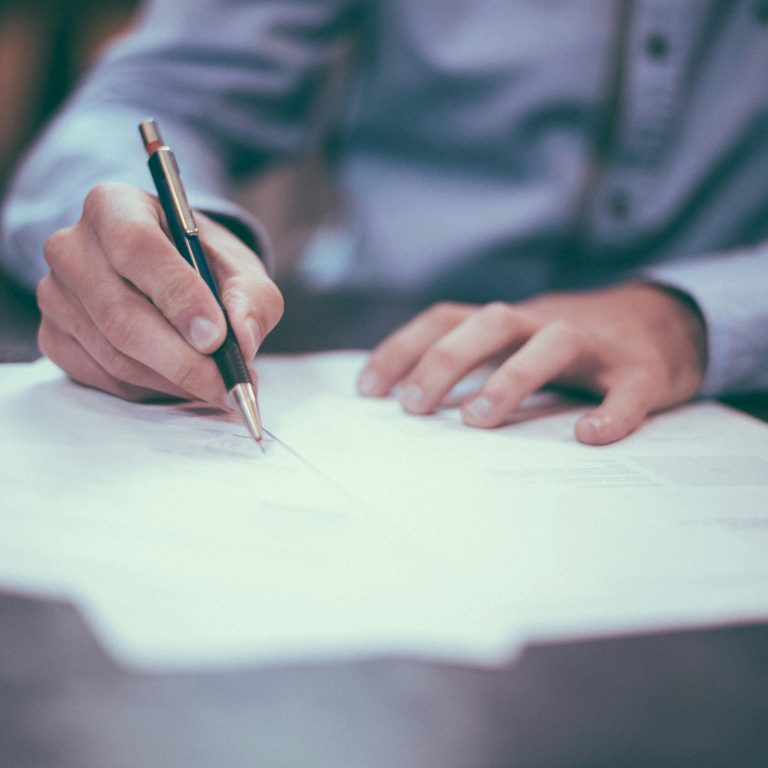 Someone signing some paperwork